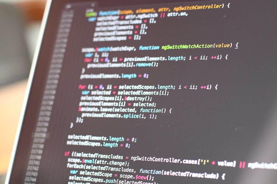 A close-up of a laptop displaying lines of computer code with syntax highlighting, set against a dark background illuminated by pink and blue ambient lighting. The screen shows a programming environme